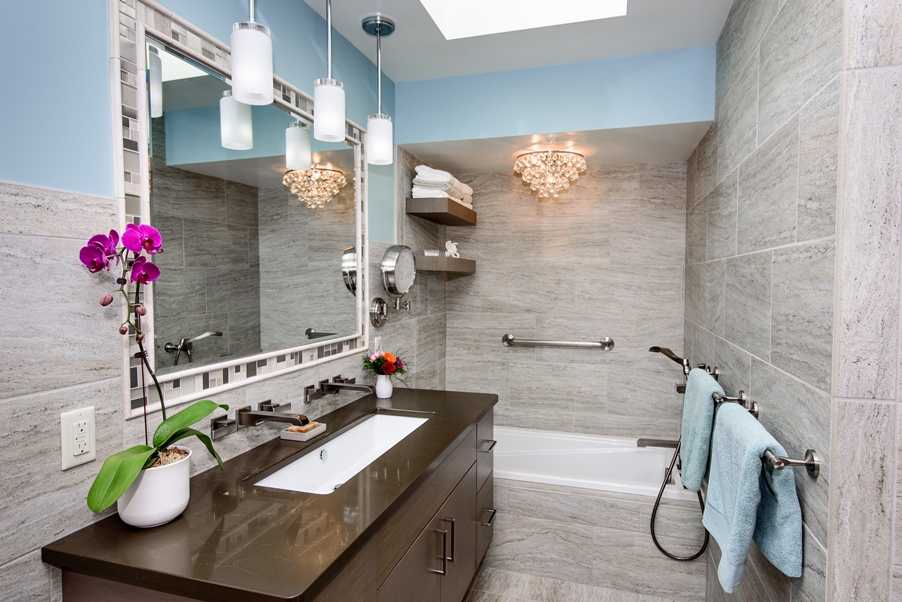 A mirror on a wall over a beautiful single sink vanity installed by a bathroom remodeling contractor in Sylvania Ohio