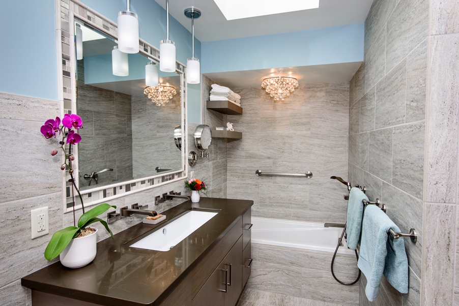 A mirror on a wall over a beautiful single sink vanity installed by a bathroom remodeling contractor in Sylvania Ohio