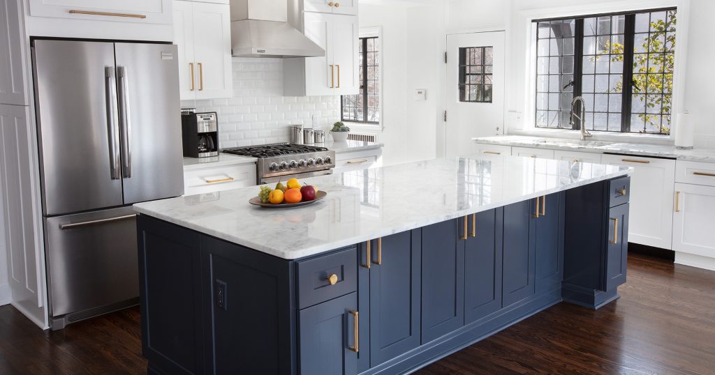 Toledo Kitchen remodeling contractor, designed a beautiful updated kitchen. A blue island creates a focal point.