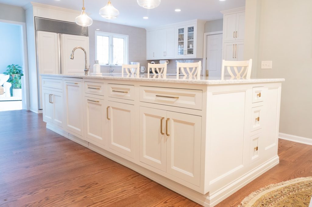 Beautiful Large white kitchen island with lots of storage and space, installed by a Maumee Ohio remodeling contractor.