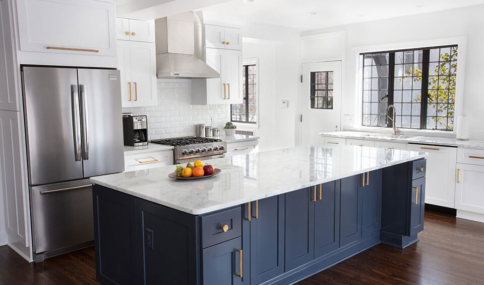 A newly remodeled kitchen in toledo ohio. It has white shaker cabinet doors and a dark navy island