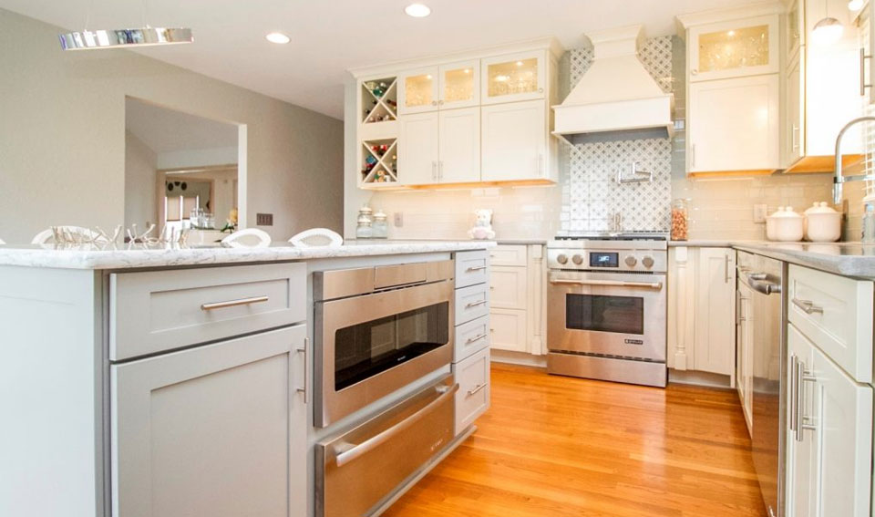 beautiful kitchen renovation in toledo ohio. the light gray cabinets are off set by a speckled gray countertop.