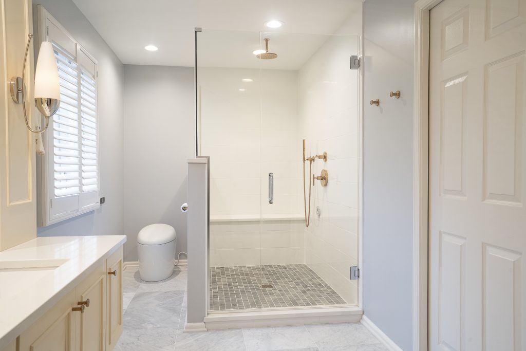 Newly tiled walk in shower in a remodeled bathroom.