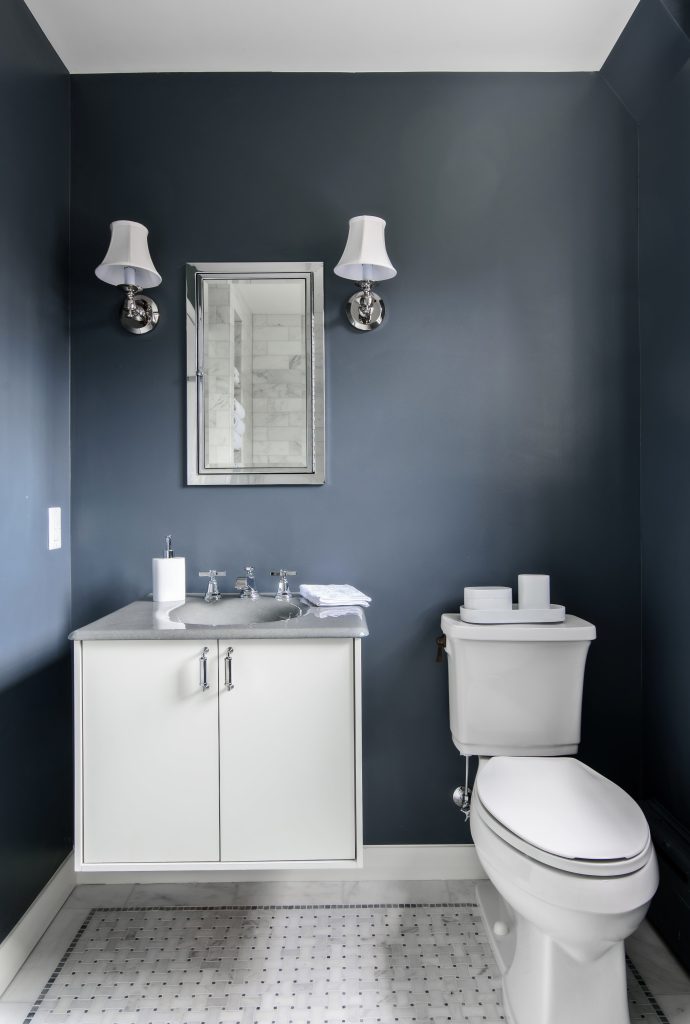 small half bath remodeling project featuring dark blue walls.