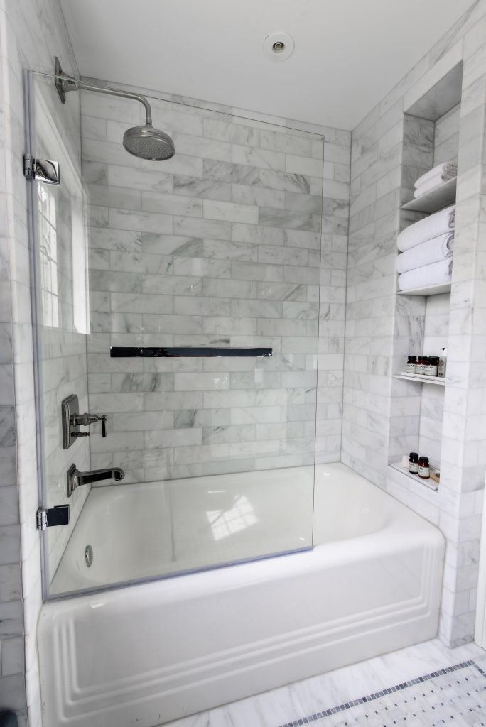 tiled bathtub shower combo with built in shelves