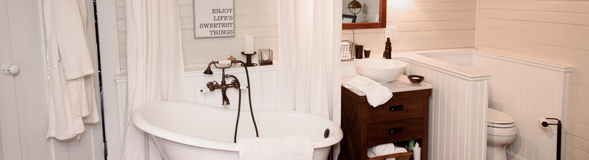 Remodeled bathroom with large stand alone tub. This remodeled bathroom in Toledo is spacious and as a half wall separating the tub from the toilet.