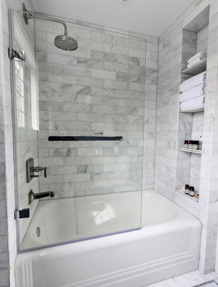 Newly tiled tub and shower with shelving