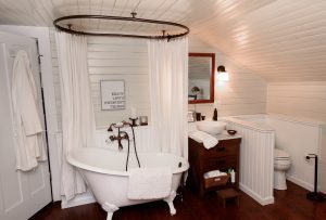 Newly remodeled bathroom with white shiplap and a clawfoot tub.