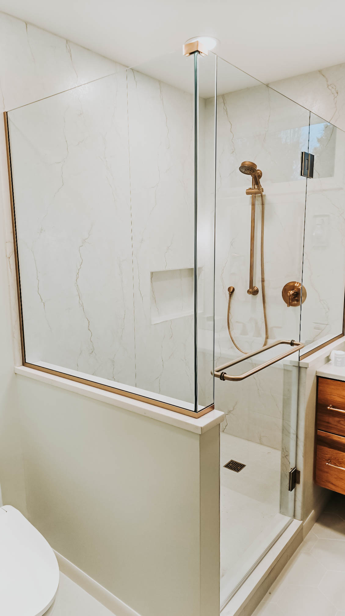 Close up of a white marbled shower in a renovated bathroom. 
