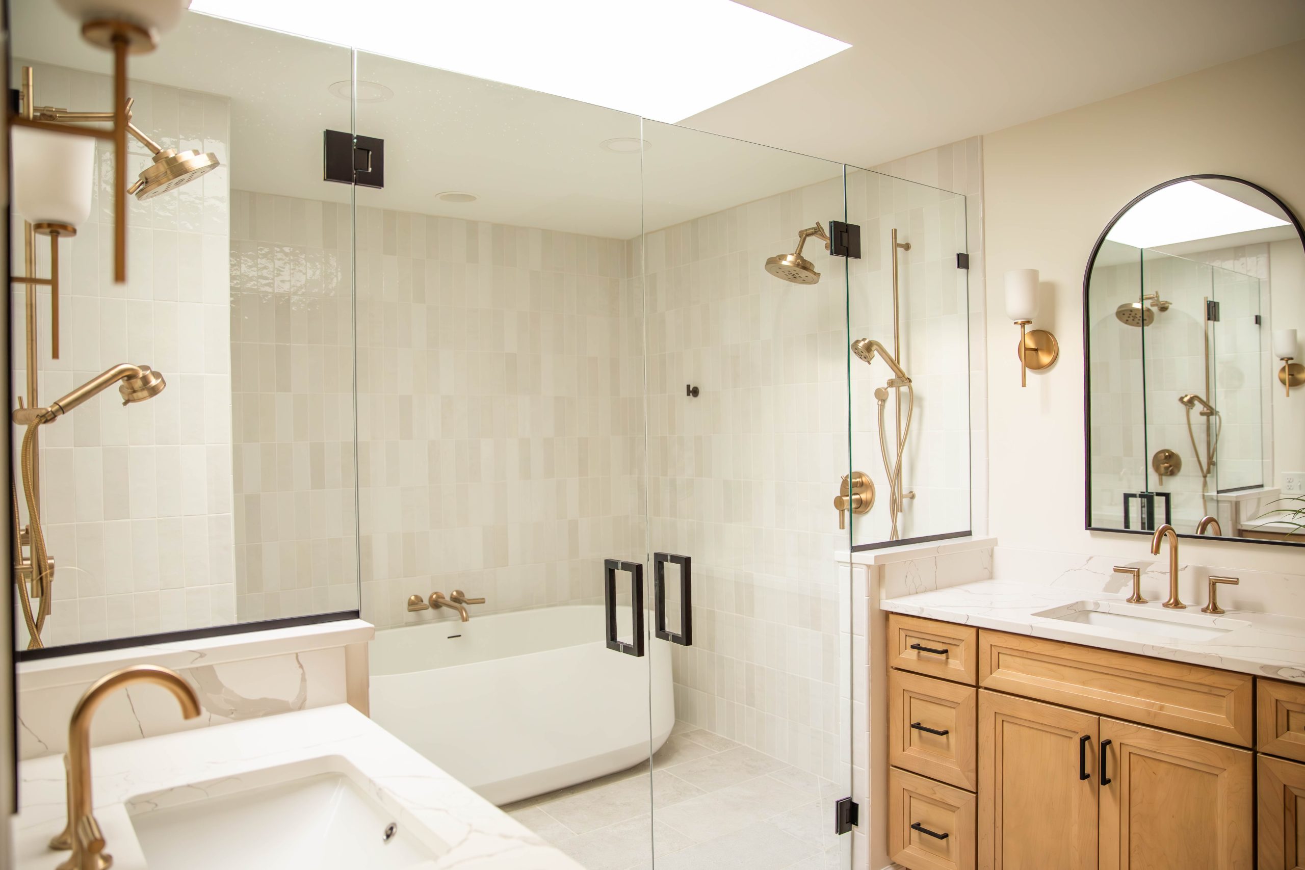 Recently remodeled luxury bathroom with double glass shower doors, walk in shower, freestanding soaker tub and dual vanities. 