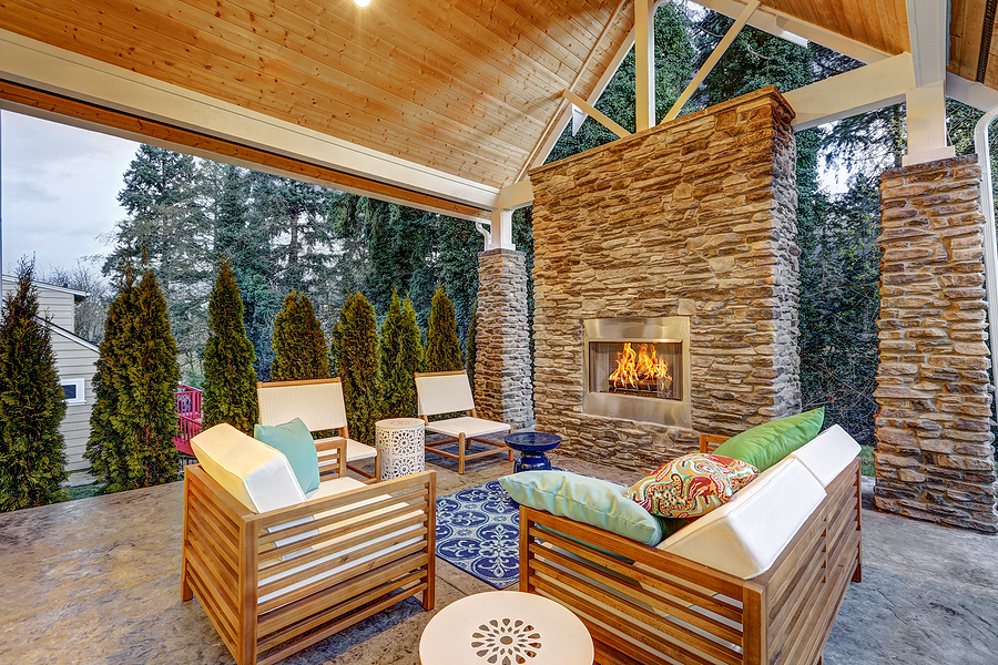 Outdoor covered patio with brick fireplace