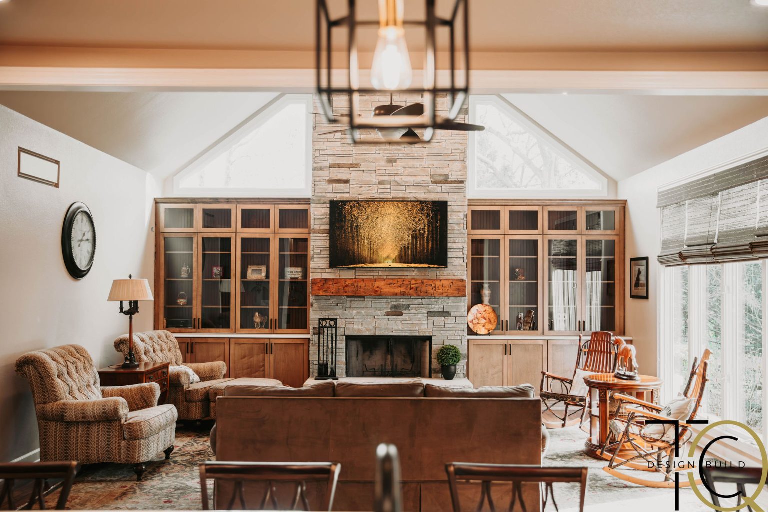 Monclova, Ohio living room remodel featuring custom stone fireplace, natural wood built-ins, and open concept home design.