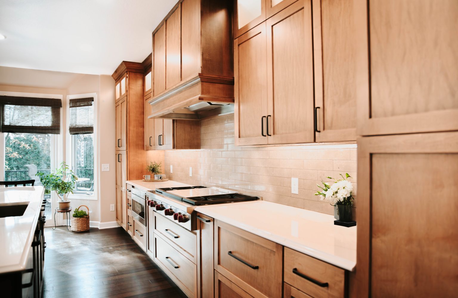 Close-up of kitchen counter with natural wood cabinets and built-in stainless steel appliances.