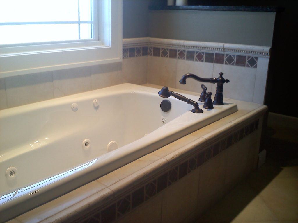Remodeled bathroom with a separate freestanding tub with jets. 