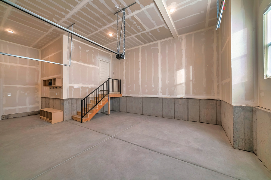 Large empty garage that is being renovated for optimal storage. 