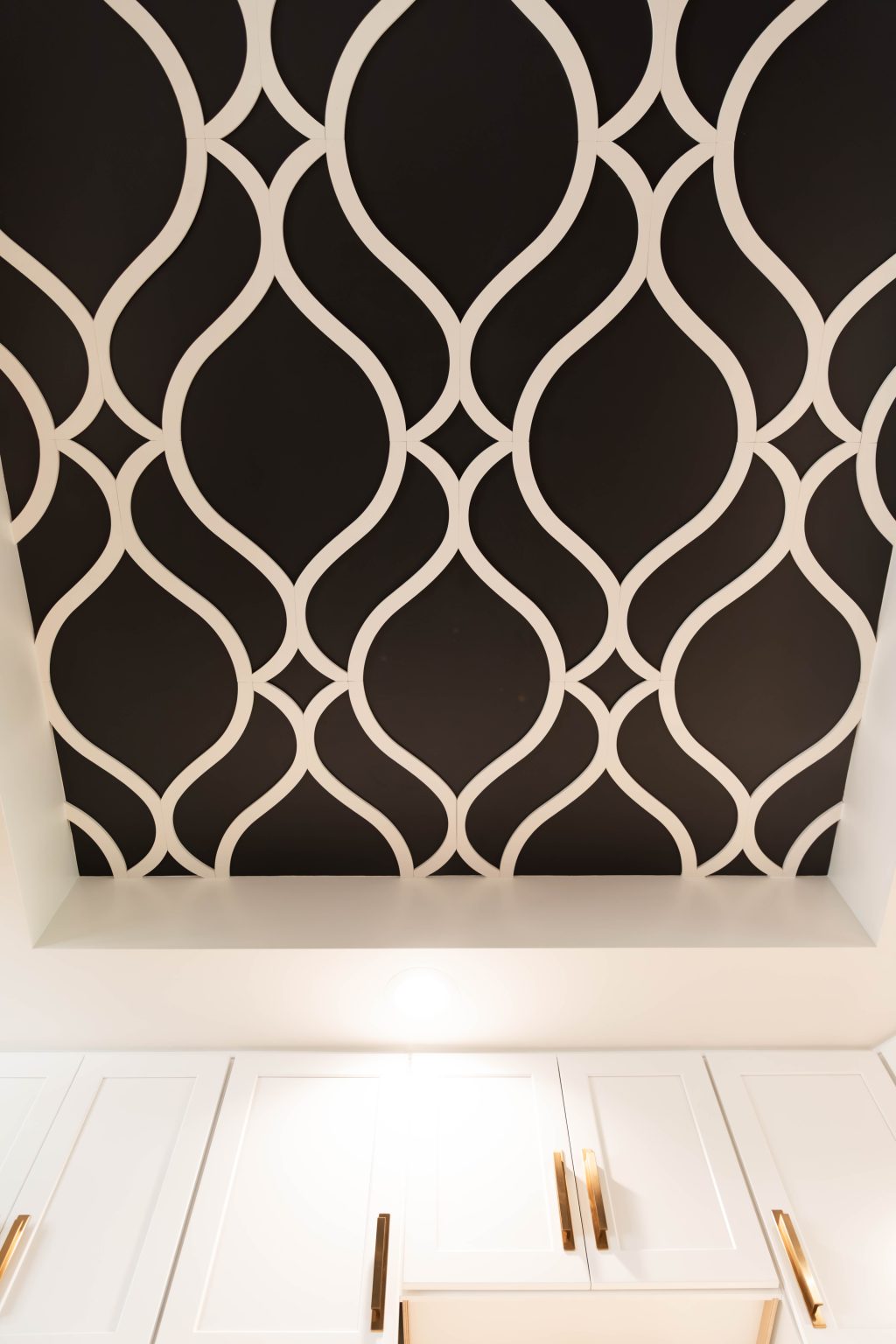 Closeup of a black and white ceiling fan in a recently renovated Ohio kitchen.