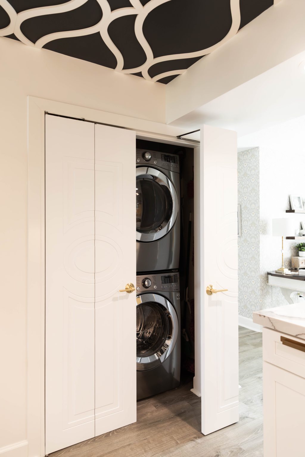Hidden laundry closet with white sliding doors
