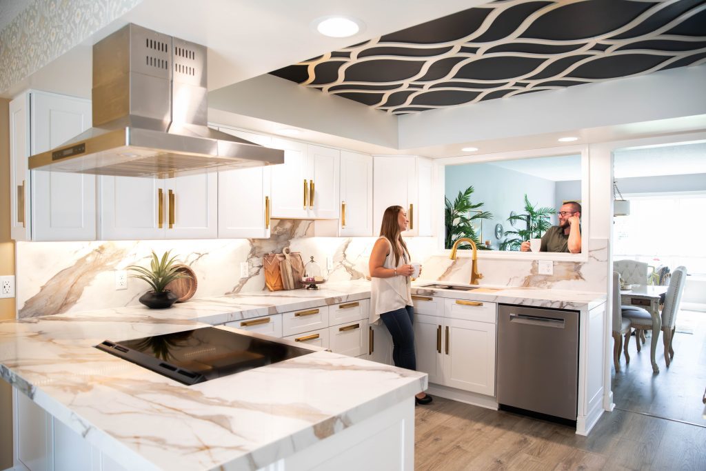 Couple standing in their recently renovated kitchen. 